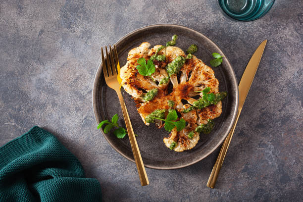 istock cauliflower steaks with herb sauce and spice. plant based meat substitute 1290729549