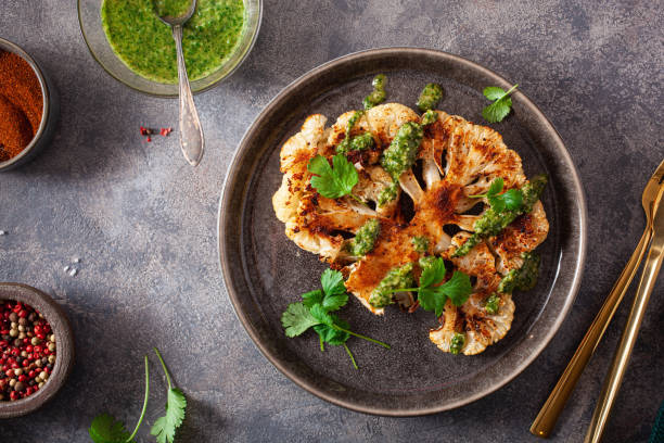 istock cauliflower steaks with herb sauce and spice. plant based meat substitute 1290730137