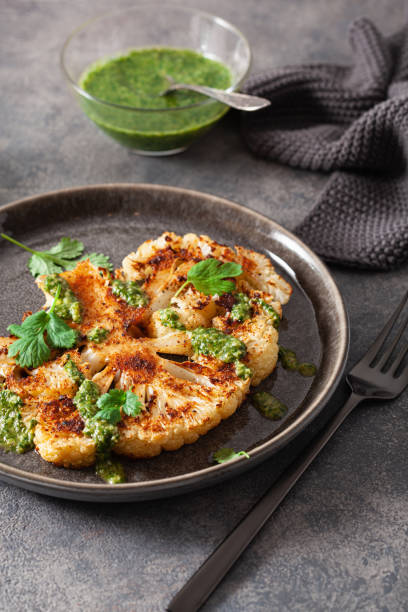 istock cauliflower steaks with herb sauce and spice. plant based meat substitute 1290730170