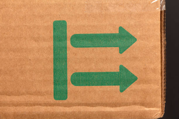istock Surface of a cardboard box with two green arrows 1290730698