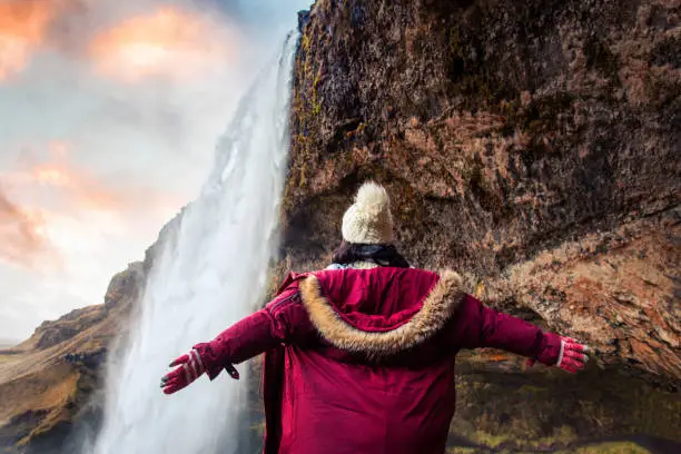 Photo of Woman enjoying visiting a waterfall view in Iceland