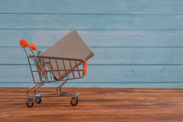 istock Shopping trolley with cardboard box. Black Friday concept 1290732748