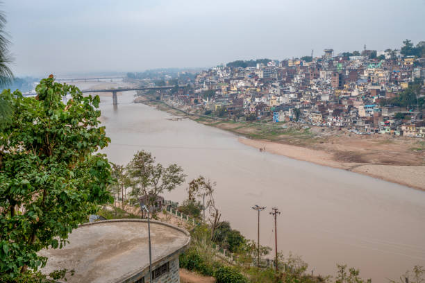Aerial cityscape of Jammu from Bag-i-Bahu park. Traffic on bridge in left corner . River Tawi Aerial cityscape of Jammu from Bag-i-Bahu park. Traffic on bridge in left corner . River Tawi tawi tawi stock pictures, royalty-free photos & images