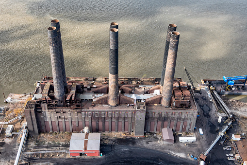 Aerial view of an old 19th century factory along the banks of the Mississippi River on the Illinois side across from the city of St. Louis, Missouri.