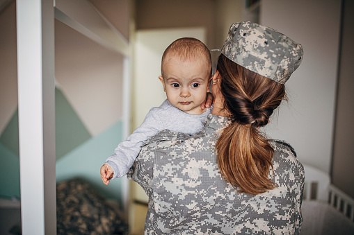 One young woman, soldier, returns from military service and meeting her baby boy after a long time.