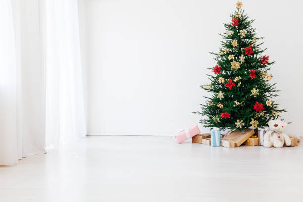 istock Beautiful holdiay decorated room with Christmas tree with presents under it. New year background 1290742006
