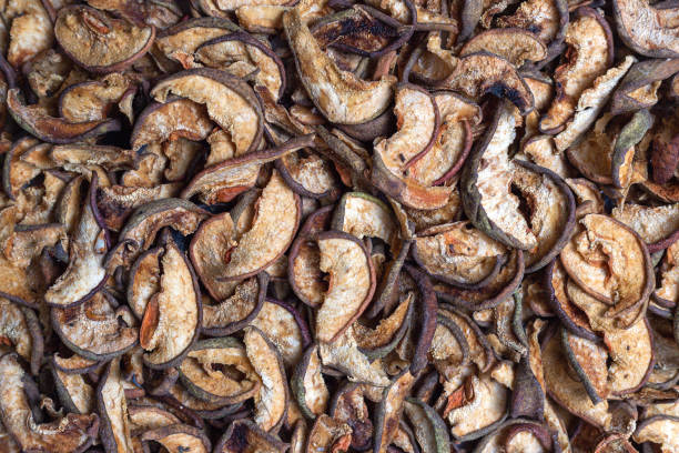 istock Scattered dried apple and pear slices texture. 1290742209