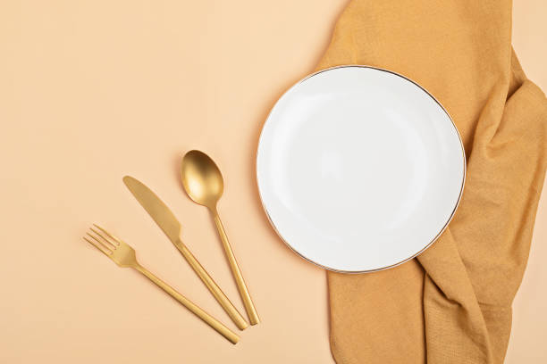 istock Empty white plate and cotton napkin on pink backdrop. Food background for menu, recipe book. Table setting. Flatlay, top view 1290744853