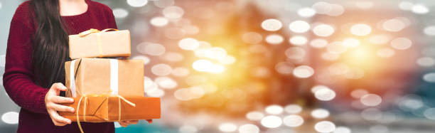 Holding Gift with bokeh background. coronavirus and christmas concept