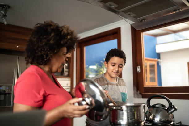 istock Boy cooking with grandmother at home 1290747064