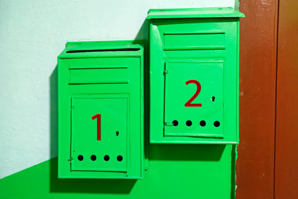 istock Old mailboxes. On the wall there are mailboxes with apartment numbers. 1290747108