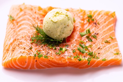 Fresh raw Salmon Milanese with Basil Pesto Butter on white background