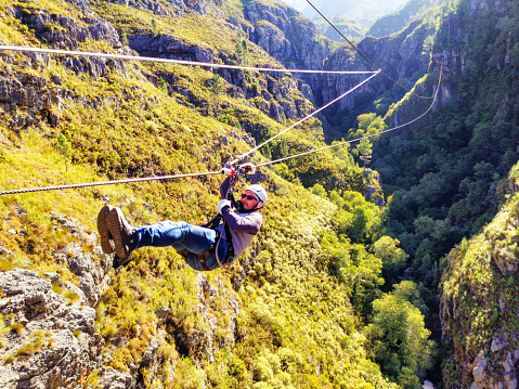 Young man on a zip line in Hottentots Holland Nature Reserve South Africa