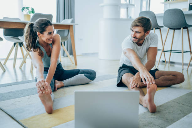 pareja haciendo ejercicio juntos en casa. - stretching boyfriend indoors lifestyles fotografías e imágenes de stock