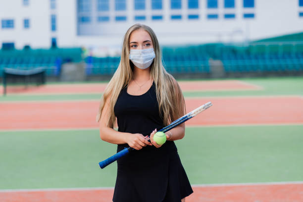 istock Female tennis player playing with protective mask 1290755364