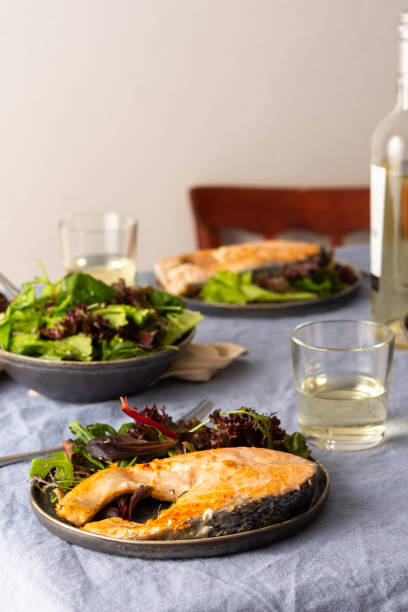 istock Fried salmon steak with salad 1290758381