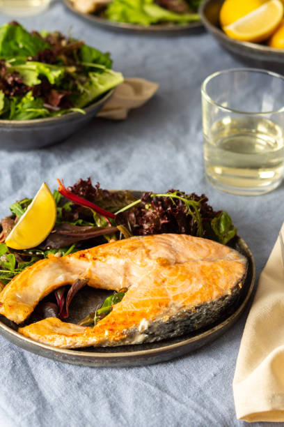 istock Fried salmon steak with salad 1290758387