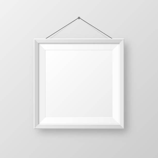 istock Realistic hanging on a wall blank white picture frame with shadow. Modern poster mockup isolated on gray background. Empty photo frame for art gallery or interior. Vector illustration 1290758574