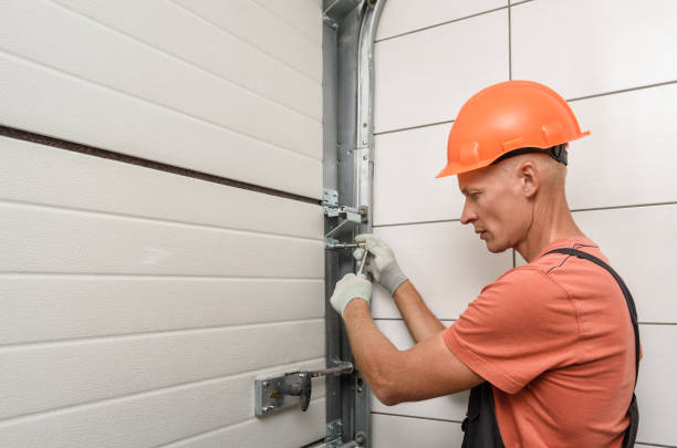 The worker is installing lift gates in the garage. Worker is installing lift gates in the garage. vehicle door stock pictures, royalty-free photos & images