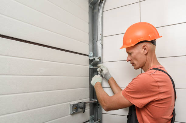 The worker is installing lift gates in the garage. Worker is installing lift gates in the garage. shutter door stock pictures, royalty-free photos & images