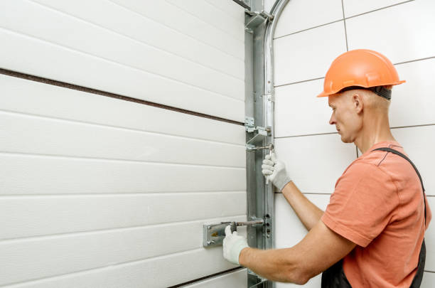 Worker is installing lift gates in the garage. The worker is installing lift gates in the garage. car door panels stock pictures, royalty-free photos & images