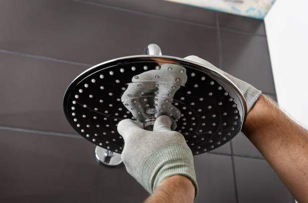 Installing the head of the built-in shower faucet. The worker's hands install the head of the built-in shower faucet. plumbing fixture stock pictures, royalty-free photos & images