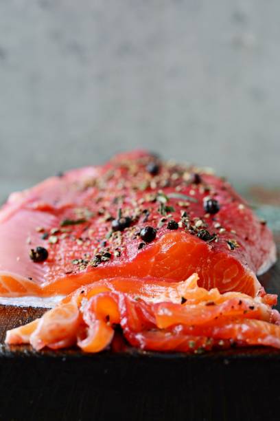 istock Gravlax, scandinavian beet cured spiced salmon on the board, top view, salted red fish 1290765310