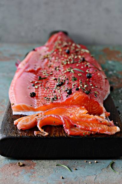 Gravlax, scandinavian beet cured spiced salmon on the board, top view, salted red fish