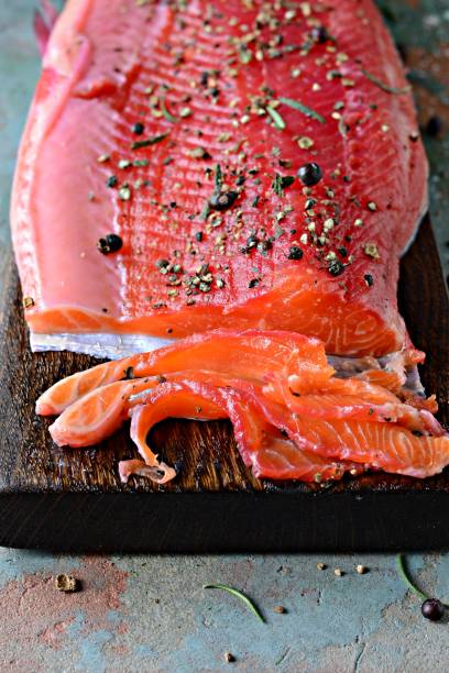 istock Gravlax, scandinavian beet cured spiced salmon on the board, top view, salted red fish 1290765334