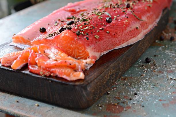 istock Gravlax, scandinavian beet cured spiced salmon on the board, top view, salted red fish 1290765336