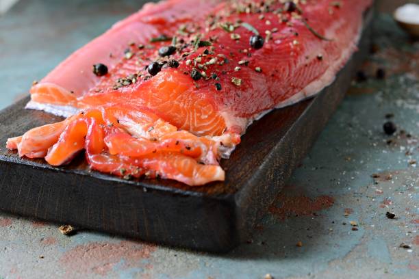 istock Gravlax, scandinavian beet cured spiced salmon on the board, top view, salted red fish 1290765337