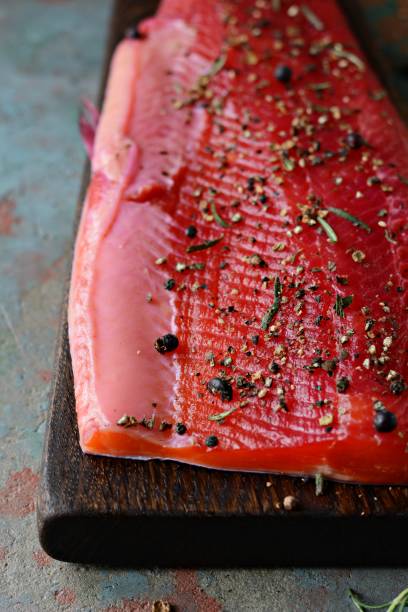 istock Gravlax, scandinavian beet cured spiced salmon on the board, top view, salted red fish 1290765339