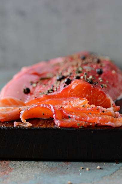 istock Gravlax, scandinavian beet cured spiced salmon on the board, top view, salted red fish 1290765340