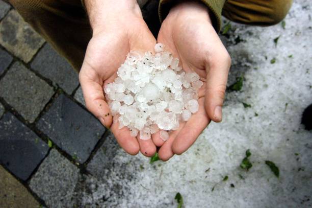 istock Holding hail stones in hand after hailstorm 1290769080