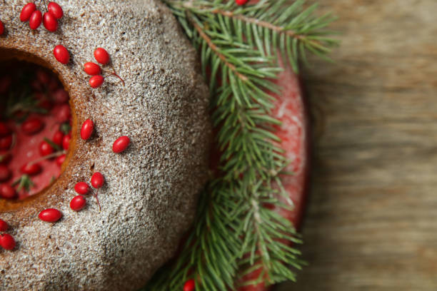 istock Bundt cake decorated with red berries on rustic wooden table. 1290769132