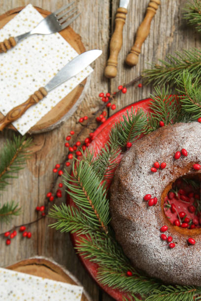 istock Bundt cake decorated with red berries on rustic wooden table. 1290769426