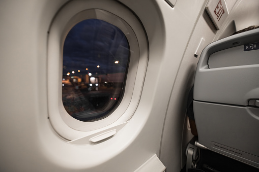 Airplane window during a flight at night during the coronavirus