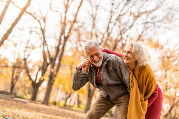 istock Playful senior couple having fun outdoors on an autumn day. 1290771025