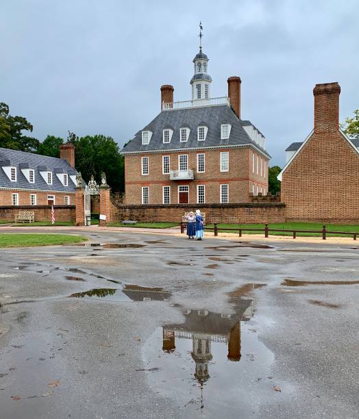 Governor's Palace Reflected in Puddle in Williamsburg, Virginia. USA Williamsburg, VA, USA - September 29, 2020: A rainy day view of the Governor's Palace, the home for the Royal Governors in Williamsburg, Virginia, USA. governor's palace williamsburg stock pictures, royalty-free photos & images