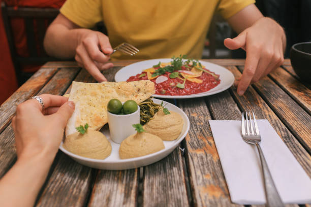 istock Couple Eating Lunch with Hummus and Risotto 1290772802