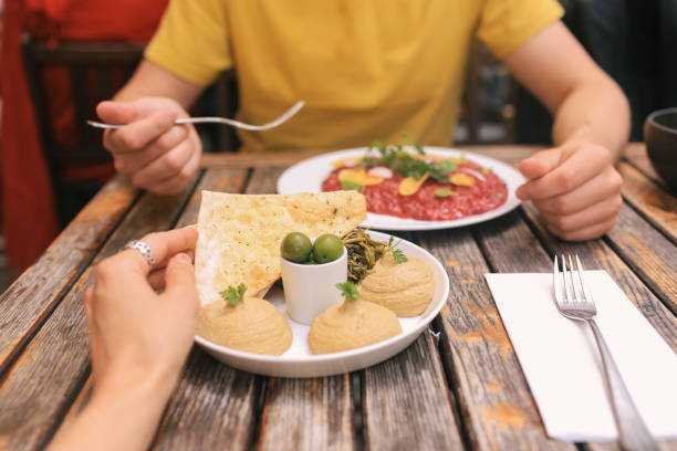 istock Couple Eating Lunch with Hummus and Risotto 1290772829