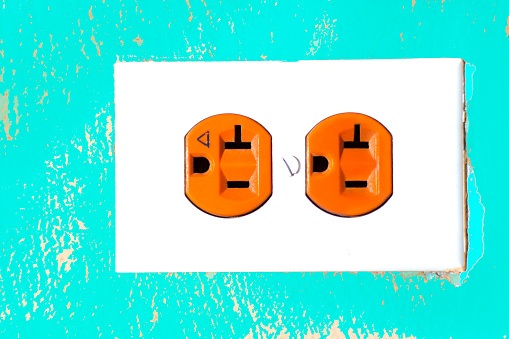 Colorful (Orange and Turquoise) Electrical Outlet Close-Up