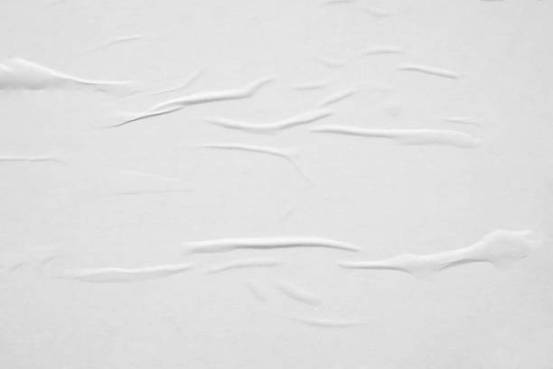 istock Blank white crumpled and creased paper poster texture background 1290775286