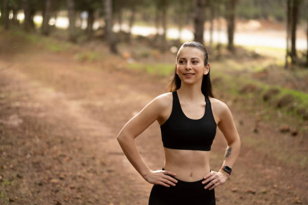 istock Young female athlete jogging in forest. Jogger doing morning physical training. 1290780129