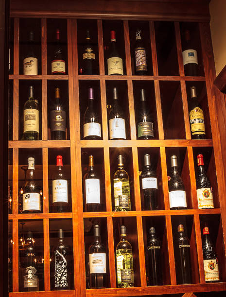 istock Wine bottles lined up and displayed in a wine cellar 1290780524