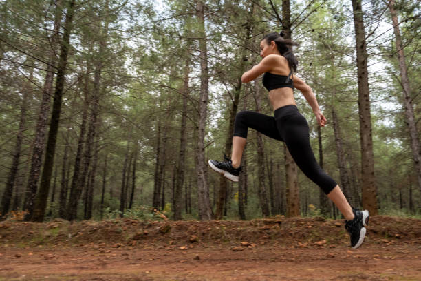 istock Young female athlete jogging in forest. Jogger doing morning physical training. 1290780916