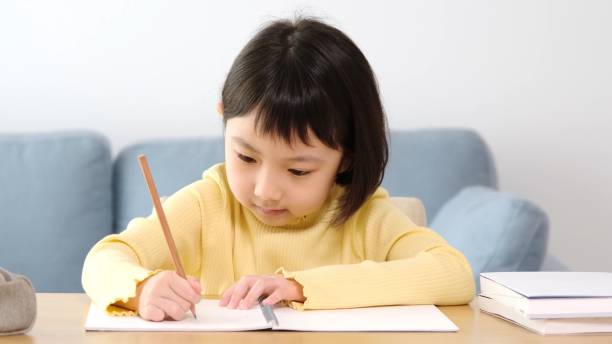 istock young asian girl studying at home 1290783197