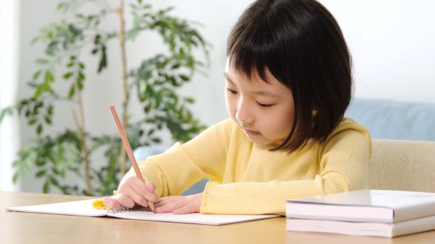 istock young asian girl studying at home 1290783218