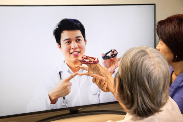 istock Elderly woman using physical therapy online service at home. 1290788482