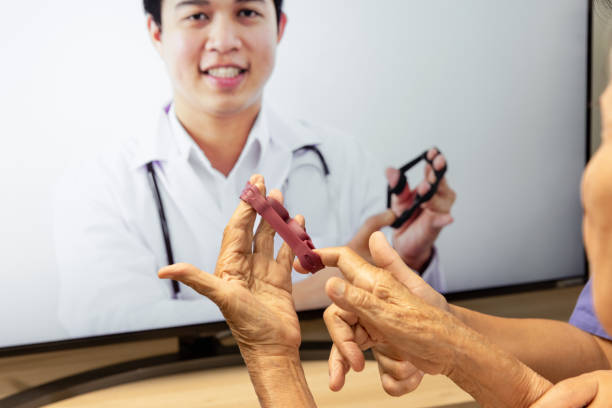 istock Elderly woman using physical therapy online service at home. 1290788486